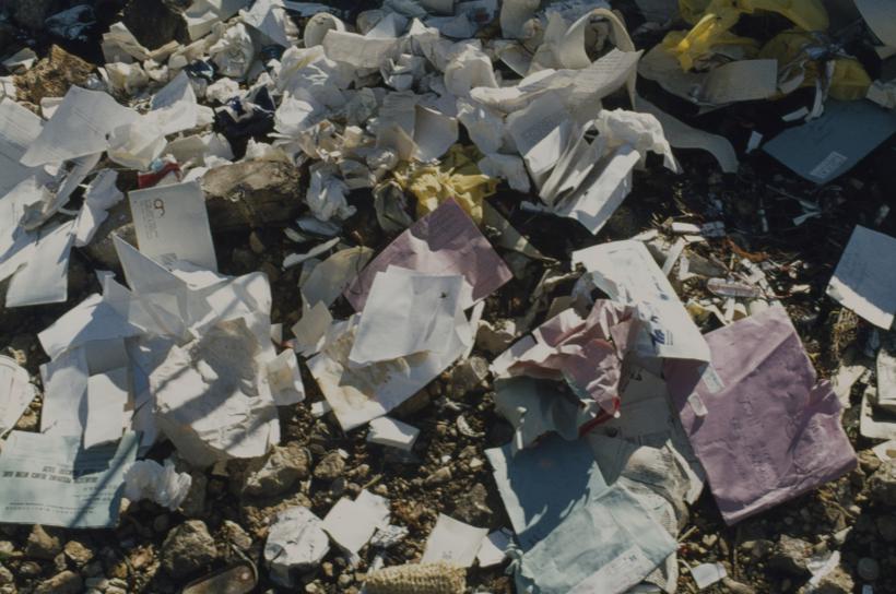 Tvornička korispodencija - papir na otpadu pored tvorničkog zida 